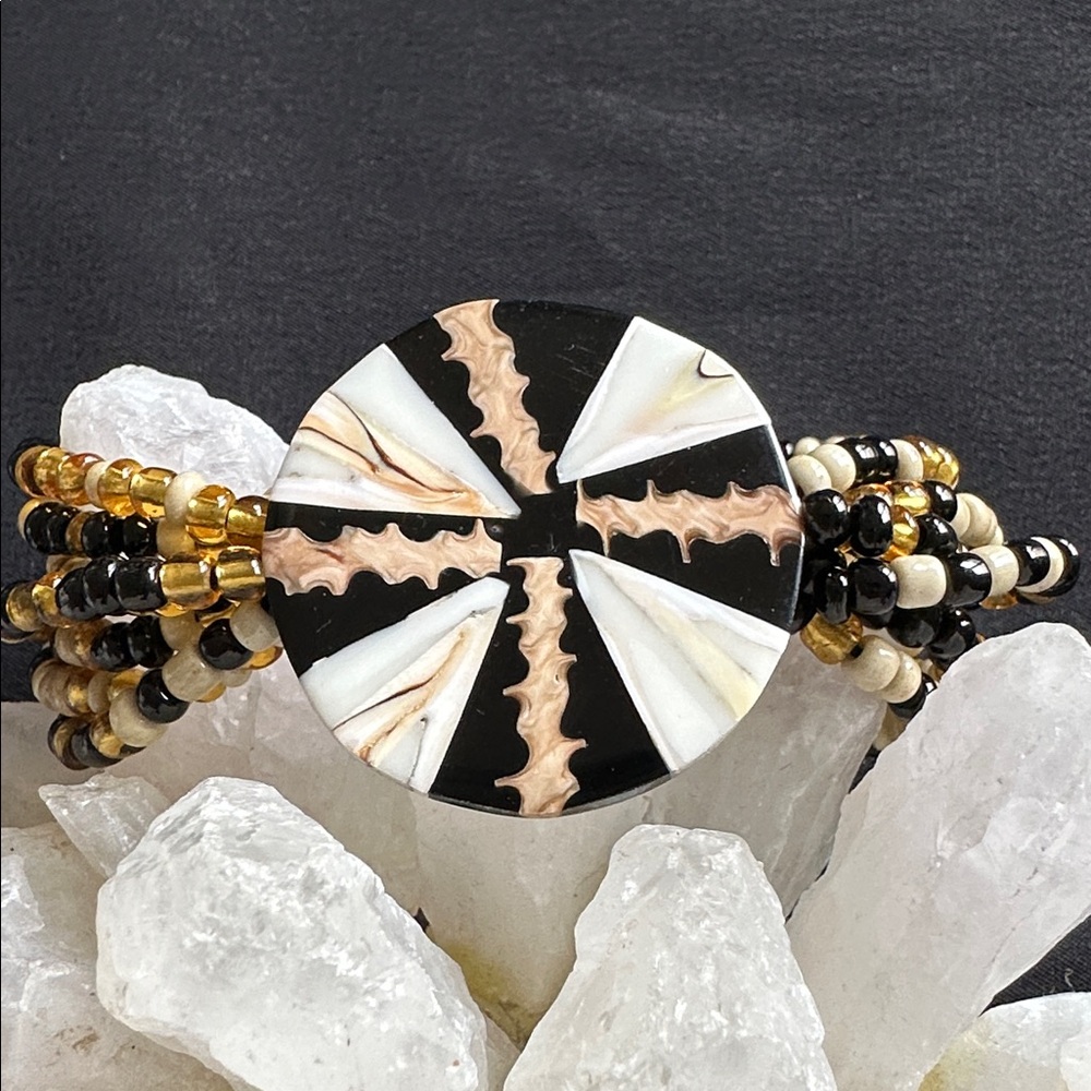Shell inlay medallion EUC stretch bracelet with seed beads & resin backing.